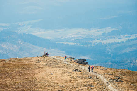 unidentified hikers travel in the Babia Gora Mountain with a backpackesの写真素材