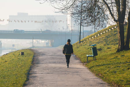 Young sporty woman running in the city at sunriseの写真素材