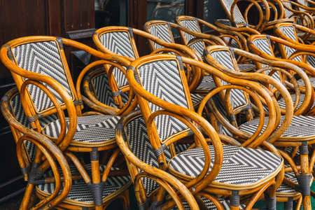 Many empty wooden chairs outside the restaurantの写真素材