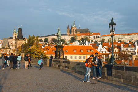 Prague, Czech Republic, October 01, 2017: Tourists visit Charles Bridge during the sunrise, Pragueのeditorial素材