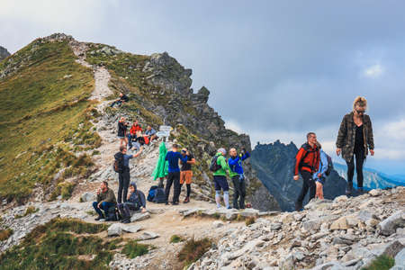 Tatra Mountains, Poland, August 14, 2017: Unidentified group of hikers resting and exhausted at Krzyzne Pass in High Tatra Mountains, Polandのeditorial素材