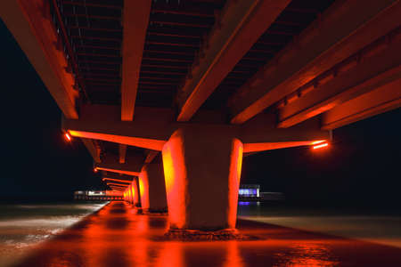 night view of the pier illuminated in red color, kolobrzeg, Polandの写真素材