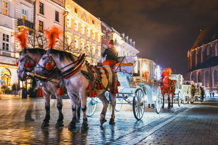 Krakow, Poland - December 15, 2017: Horse-drawn carriage before the Sukiennice on The Main Market...