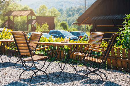 an empty table and chairs in a restaurantの写真素材