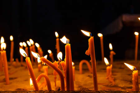 burning candles on the dark background, close upの写真素材