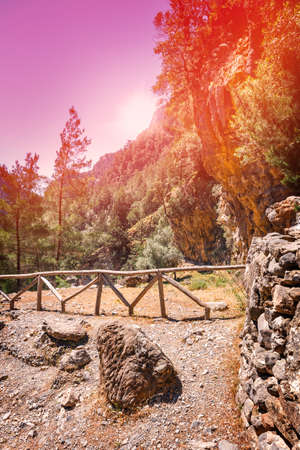 Sun is shining through the edge of canyon in Samaria Gorge in Central Creteの写真素材