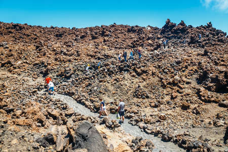 Tenerife, Spain, June 07, 2015: unknown people are walking along the mountain path at the top of the el teide volcano, Spainのeditorial素材