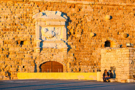 Heraklion, Crete - June 10, 2017: Unknown people are strolling through the old port of Heraklion during sunset, Crete, Greeceのeditorial素材