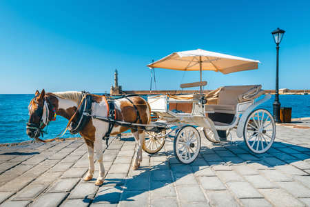 Horse carriage for transporting tourists in old port of Chania on Crete, Greeceの写真素材