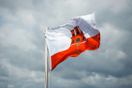 close up of Gibraltar flag waving against blue skyの写真素材