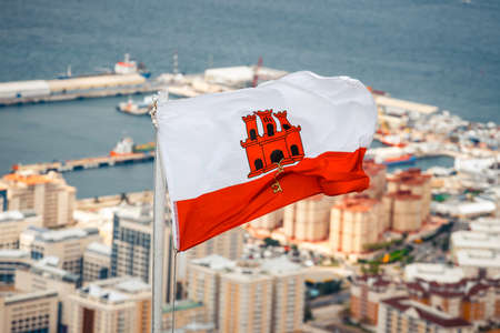 close up of Gibraltar flag waving against blue skyの写真素材