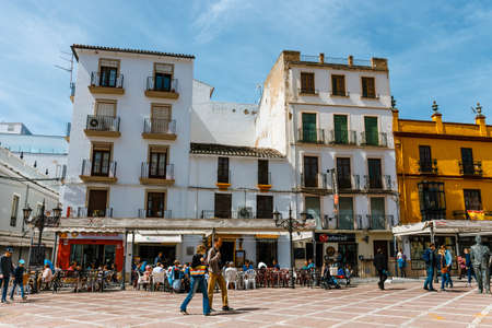 Ronda, Spain, April 05, 2018: people walking around the square Plaza del Socorro in Ronda, Spain