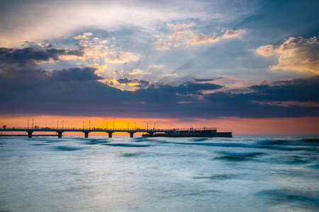 Sunset on the beach with breakwater, long time exposureの写真素材