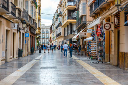 Malaga, Spain, April 03, 2018: Narrow street in the historical center of Malaga where tourists are seeking for shopsのeditorial素材