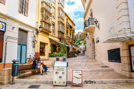 Malaga, Spain, April 03, 2018: Narrow street in the historical center of Malaga where tourists are seeking for shopsのeditorial素材