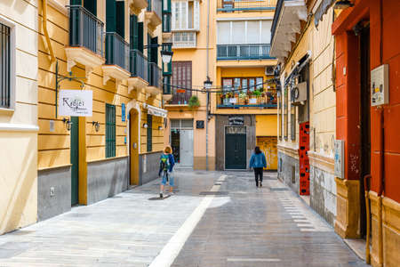 Malaga, Spain, April 03, 2018: Narrow street in the historical center of Malaga where tourists are seeking for shopsのeditorial素材