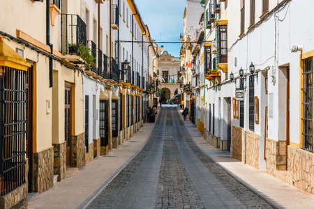 Ronda, Spain, April 05, 2018: narrow street with white facades of houses in historic district of Ronda, Spainのeditorial素材