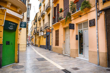 Malaga, Spain, April 03, 2018: Narrow street in the historical center of Malaga where tourists are seeking for shopsのeditorial素材