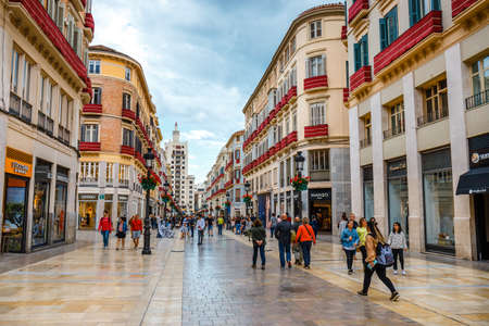 Malaga, Spain, April 03, 2018: Narrow street in the historical center of Malaga where tourists are seeking for shopsのeditorial素材