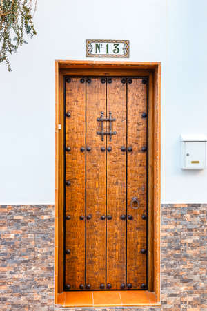 single wooden door with number thirteen on a wallの写真素材