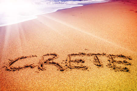 Crete inscription on the sand near the seaの写真素材