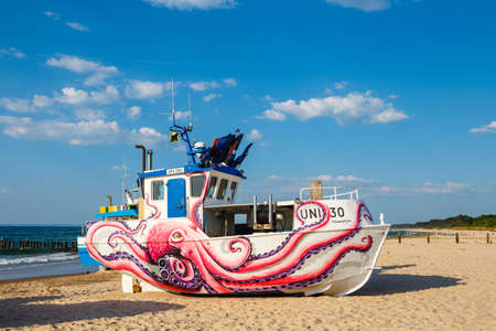 Uniescie, Poland, May 28, 2018: fishing boat painted in fanciful shapes like an octopus and a whaleのeditorial素材