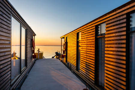floating cottage on the lake at sunriseの写真素材
