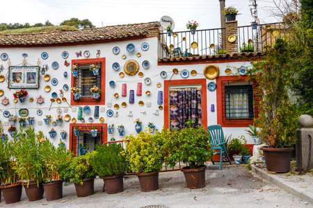 Granada, Spain, April 06, 2018: : Facade of a traditional house with decorative ceramic plates and pots of colorful flowers in the historic Albaicin neighbourhood.のeditorial素材