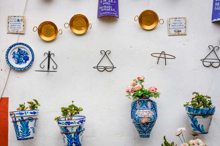 Granada, Spain, April 06, 2018: : Facade of a traditional house with decorative ceramic plates and pots of colorful flowers in the historic Albaicin neighbourhood.のeditorial素材