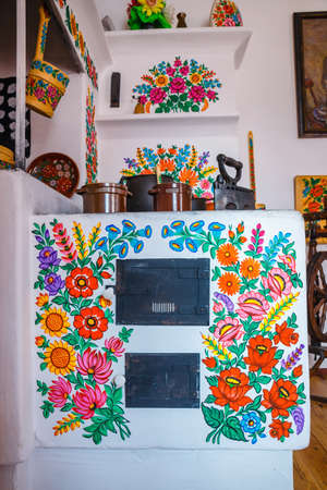 Zalipie, Poland, August 19, 2018:   Colourful room in the log house in the village Zalipie, Poland. It is known for a local custom of painting the cottages with decorative motifsのeditorial素材