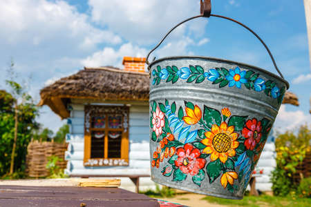 Zalipie, Poland, August 19, 2018:  A bucket over a well in the colorful village - Zalipie, Poland. It is known for a local custom of painting the cottages with decorative motifsのeditorial素材