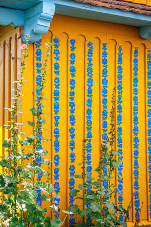 Zalipie, Poland, August 19, 2018:  Close up of colorful flowers painted on wooden cottage in Zalipie, Poland. It is known for a local custom of painting the cottages with decorative motifsのeditorial素材