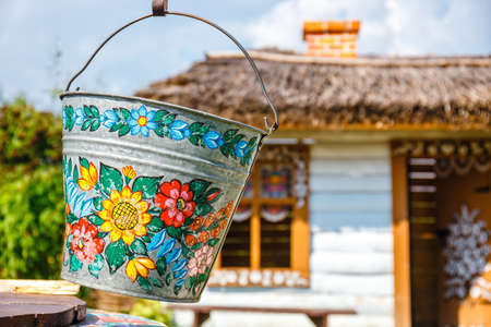 Zalipie, Poland, August 19, 2018:  A bucket over a well in the colorful village - Zalipie, Poland. It is known for a local custom of painting the cottages with decorative motifsのeditorial素材