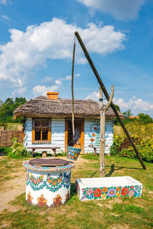 Zalipie, Poland, August 19, 2018:  A bucket over a well in the colorful village - Zalipie, Poland. It is known for a local custom of painting the cottages with decorative motifsのeditorial素材