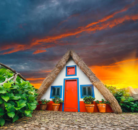 Traditional triangle house in Santana Madeira, Portugal. Sunset viewのeditorial素材