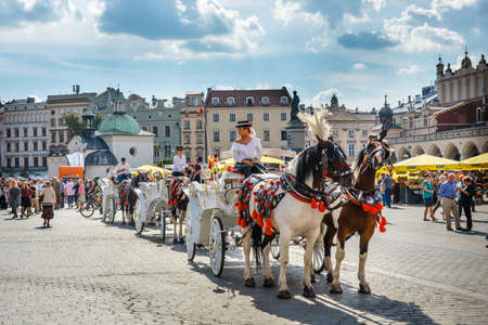 Krakow, Poland, September 16, 2018: Horse-drawn carriage before the Sukiennice on The Main Market Square in Krakow, Polandのeditorial素材