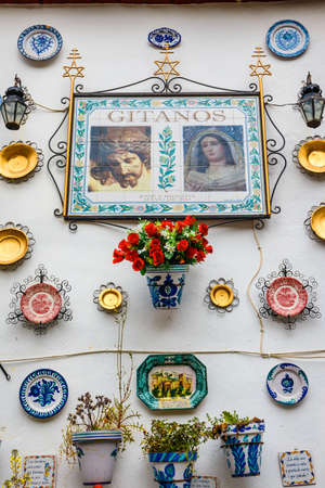 Granada, Spain, April 06, 2018: : Facade of a traditional house with decorative ceramic plates and pots of colorful flowers in the historic Albaicin neighbourhood.のeditorial素材