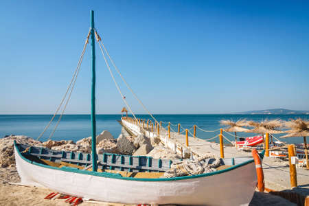Old boat on empty seaside beach, Bulgariaの写真素材