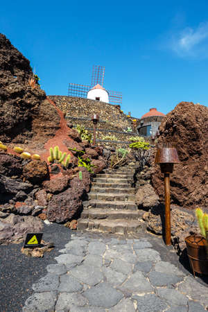Windmill on blue sky background in cactus garden, Guatiza village, Lanzarote, Canary islandsの写真素材