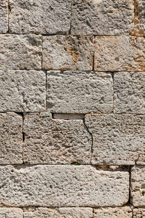 Old beige stone wall background texture, close upの写真素材