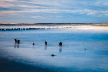 Long exposure shot of the sea and a pier in a sunset, Baltic Sea, Polandの写真素材