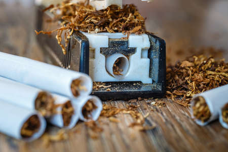 hand-made cigarettes at home using a manual machineの写真素材