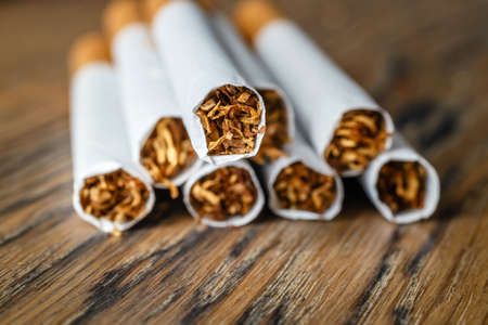Close up of a hndmade smoking cigarettes on wooden backgroundの写真素材