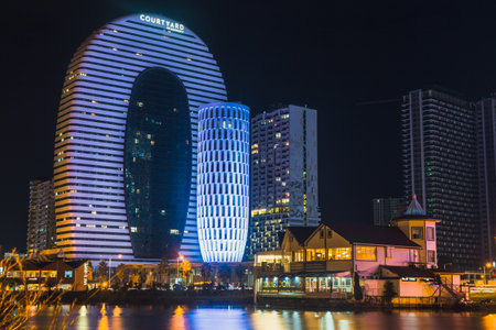 Batumi, Georgia - October 01, 2021: Modern architecture of Batumi embankment at night.のeditorial素材