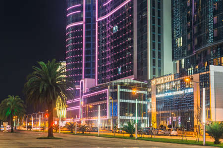 Batumi, Georgia - October 01, 2021: Modern architecture of Batumi embankment at night. Evening view of the modern hotel complex Orbi City in the city of Batumiのeditorial素材