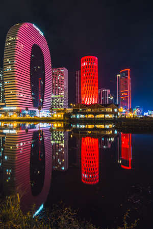 Batumi, Georgia - October 01, 2021: Modern architecture of Batumi embankment at night.のeditorial素材