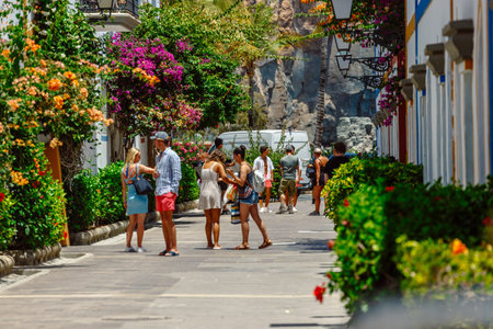 Puerto de MogÃ¡n, Gran Canaria, Spain. 18 July 2022: Narrow and flowery streets of Puerto de Mogan are eagerly visited by touristsのeditorial素材