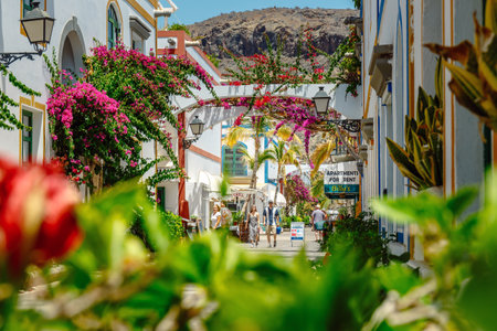 Puerto de MogÃ¡n, Gran Canaria, Spain. 18 July 2022: Narrow and flowery streets of Puerto de Mogan are eagerly visited by touristsのeditorial素材