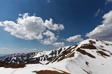 Cloudy sky over spring mountainsの写真素材