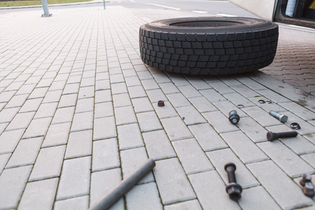 Wheel lying on the street, broken screw mountの写真素材